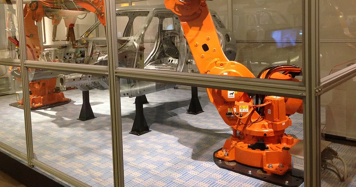 Orange industrial welding robot arms