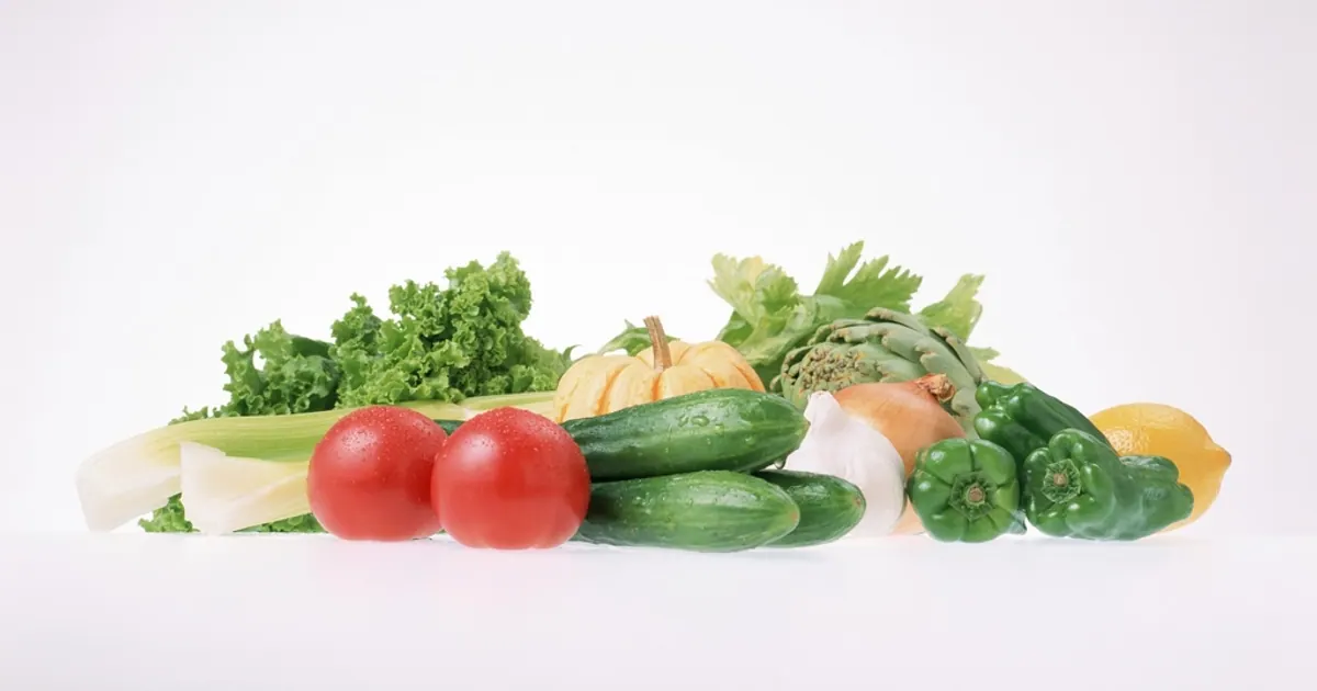 Fresh vegetables including tomatoes, cucumber and greens