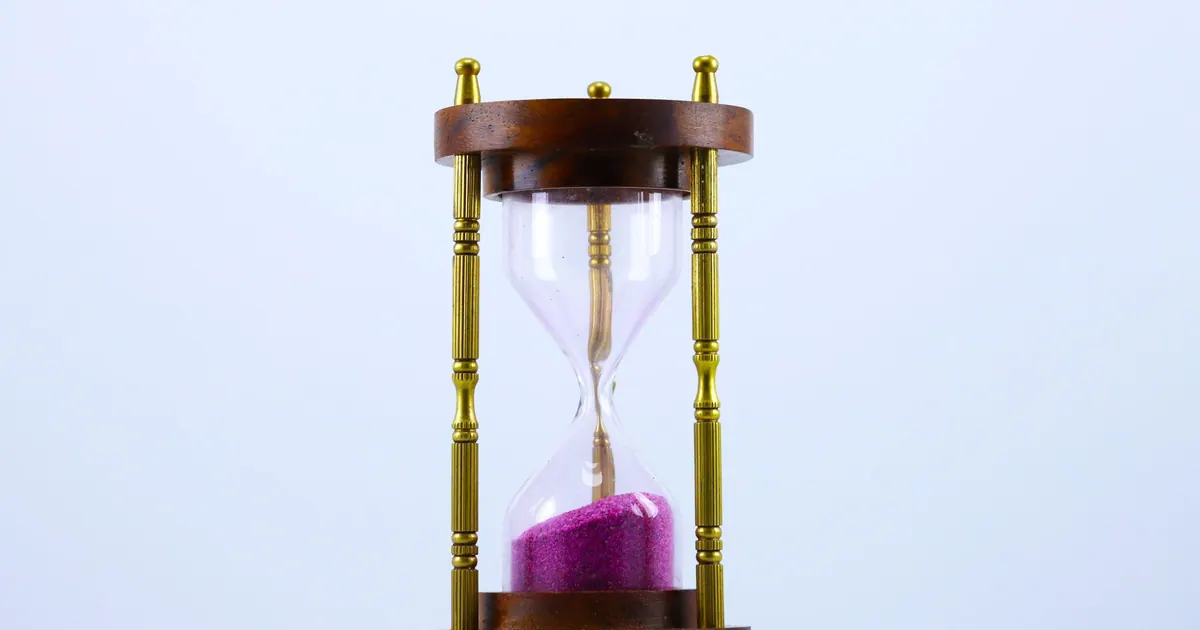 Hourglass with pink sand running through it