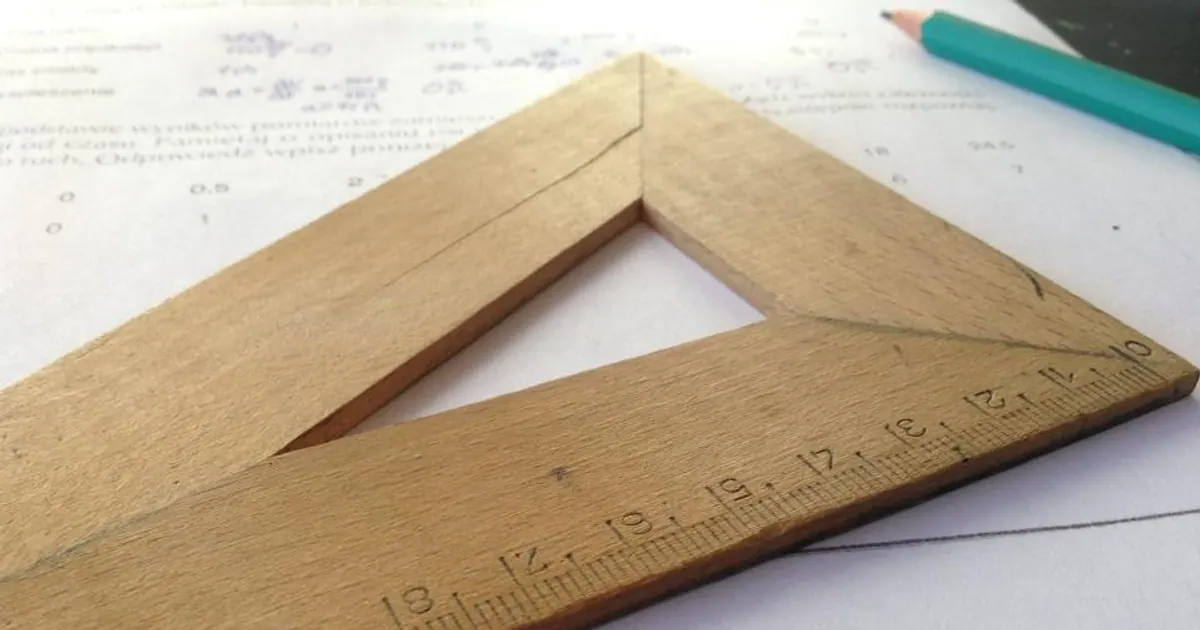 Wooden rulers and a set square on a table