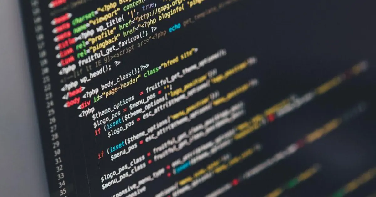 Colourful program code on a dark computer screen